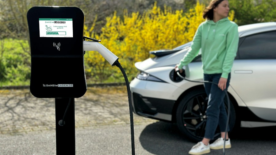 EV owner plugging in at charging station