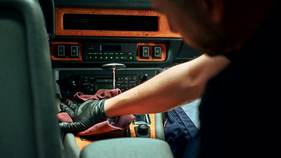 7 Tips to Clean Your Car Before a Road Trip 1 hand cleaning car dashboard cloth