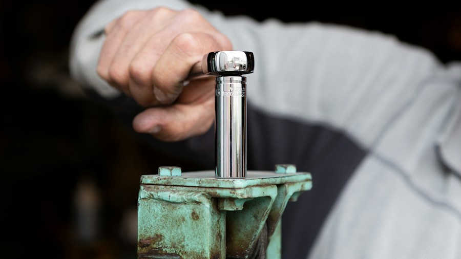 7 Essential Tips for Blowing Out RV Water Lines Before Winter 2 hands tightening blow out adapter valve
