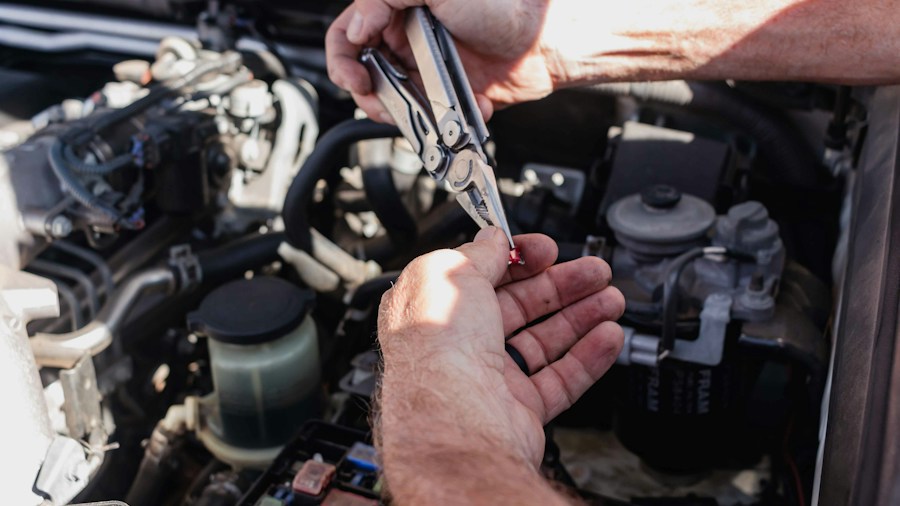 mechanic checking transmission fluid dipstick
