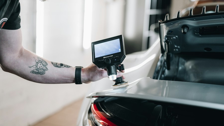 mechanic checking vehicle camera alignment