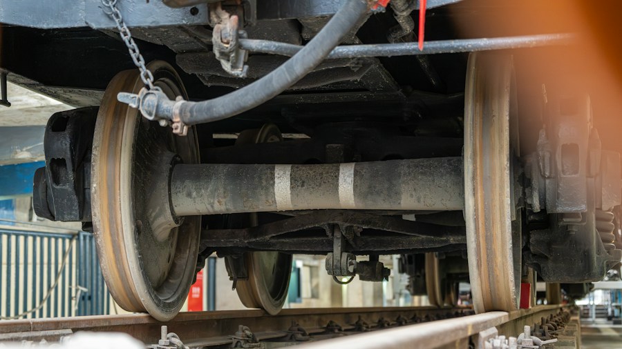 mechanic checking vehicle undercarriage
