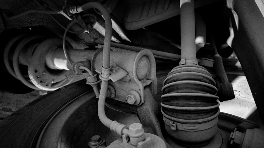 Control Arm Wear: Why Replacing Bushings in Pairs Prevents Tire Damage 1 mechanic inspecting suspension control arm