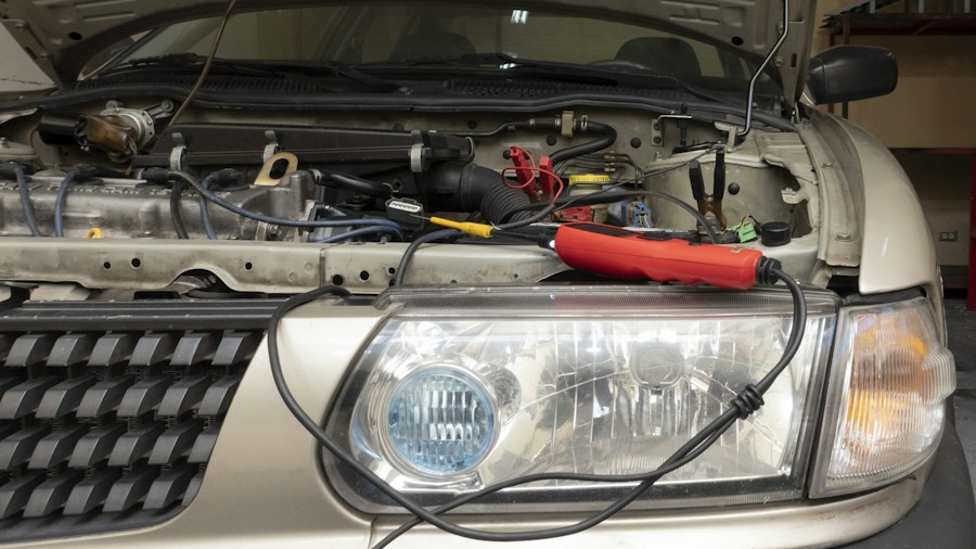 Halogen Headlight Dimming: What Drivers and Shoppers Need to Know 2 mechanics installing headlight bulb
