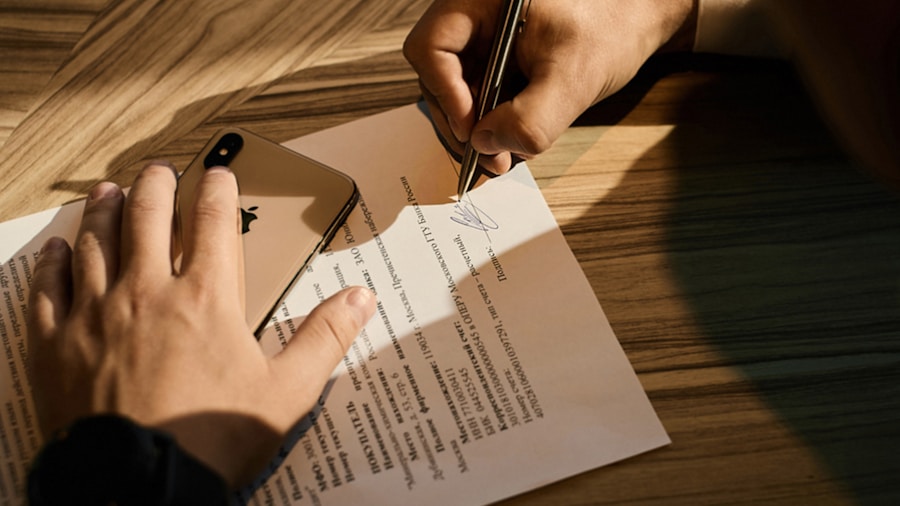 person signing car lease agreement