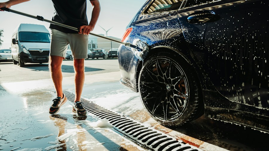 7 Tips to Clean Your Car Before a Road Trip 2 rinsing car with hose outdoors
