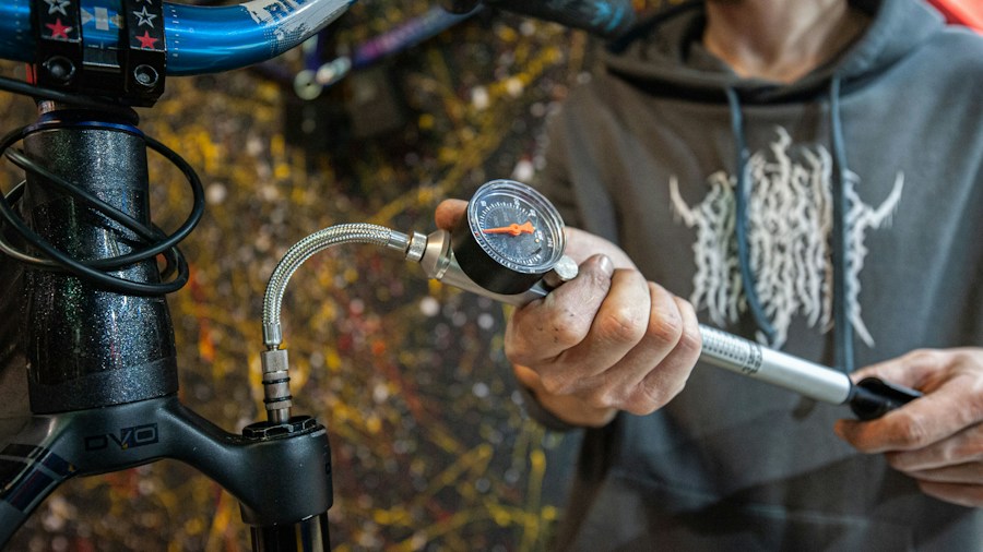 technician checking tire pressure gauge