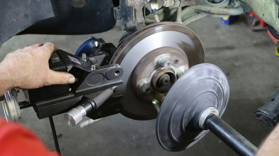 Brake Pad Fundraiser Supports Breast Cancer Research What Shoppers Need to Know 1 technician replacing brake pads
